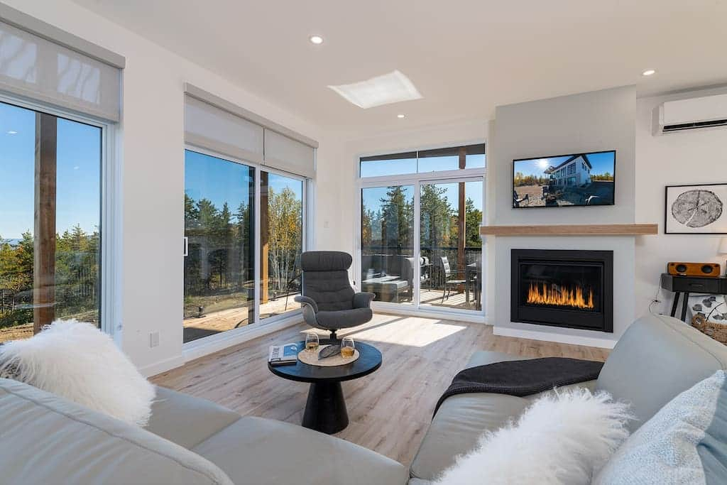 Living room with gas fireplace and large windows