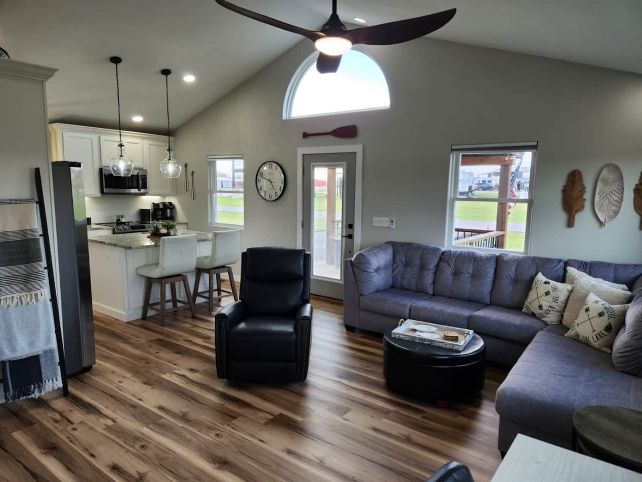 Living room sectional to stretch out on, leather recliner to relax in, and games inside the ottoman.