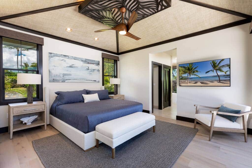 Luxurious primary bedroom with king bed and pull out TV