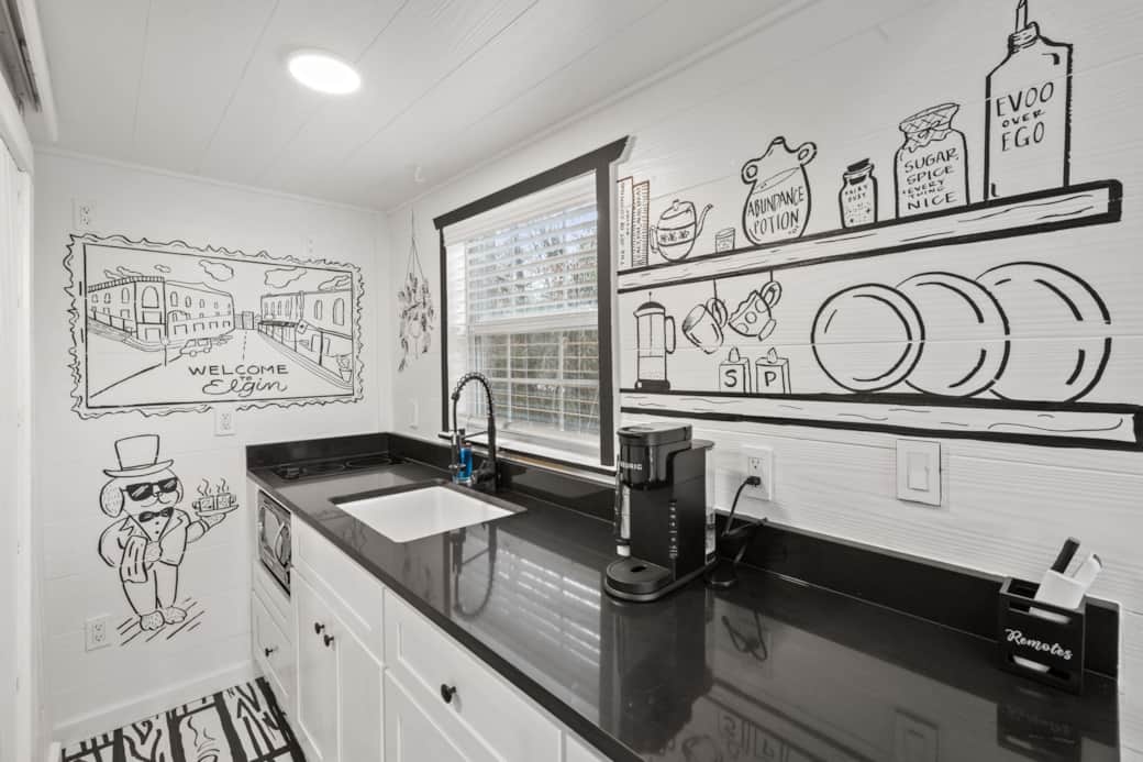 The doodle house features a kitchenette, with a burner stove, microwave, mini fridge 