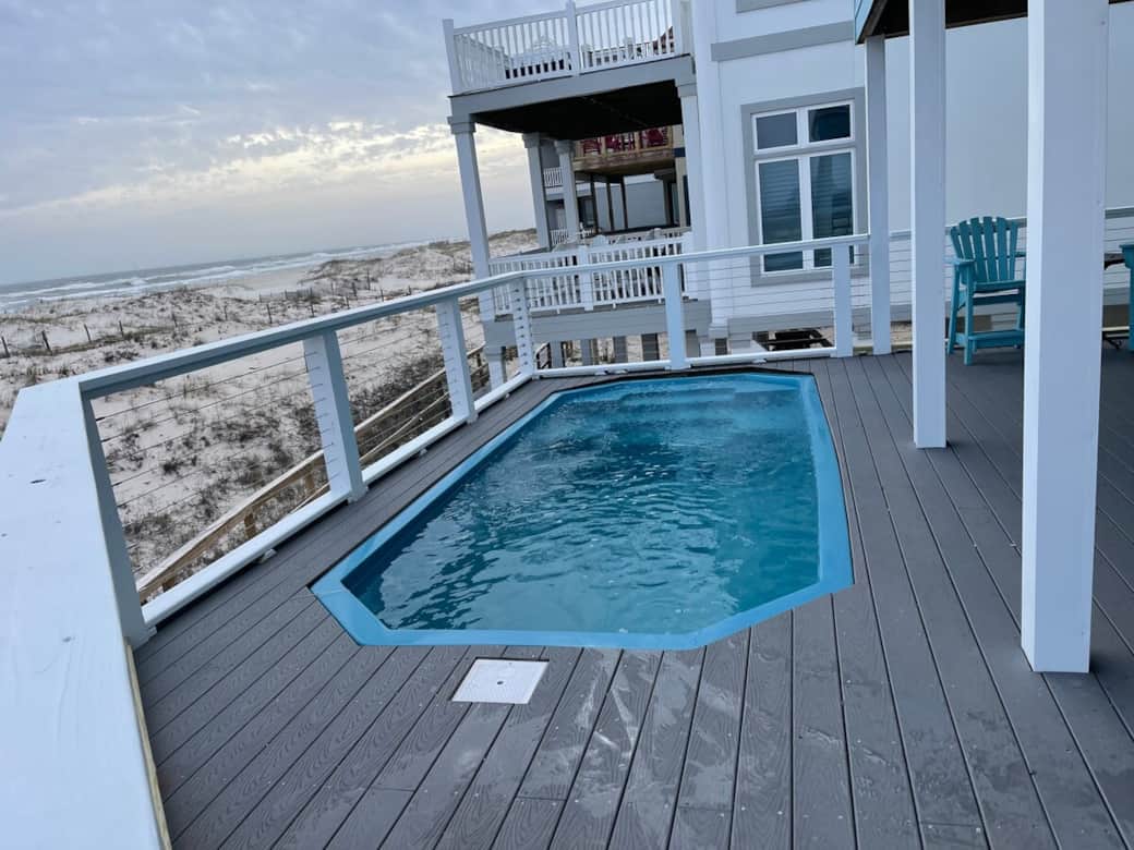 Brand new heated salt water pool!  The temperature has a top setting of 104 degrees.  Deepest part is 5 ft.  Deck was expanded on the first floor.