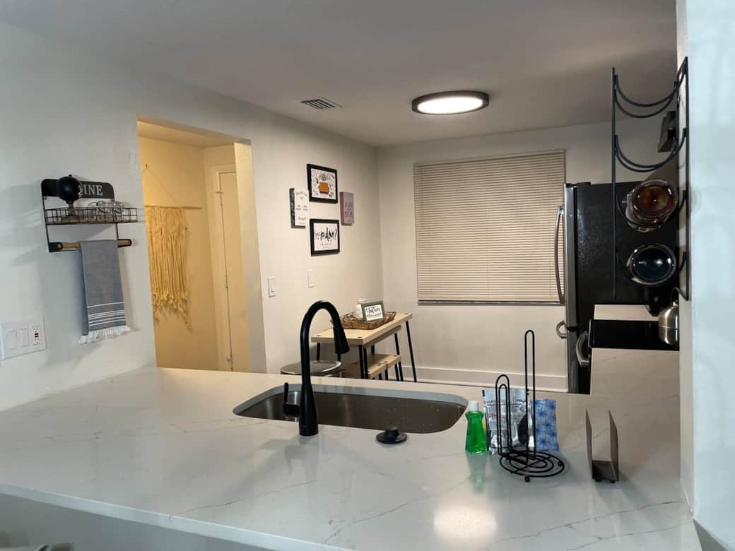 Kitchen with black accents, stainless appliances, and a café table for casual dining