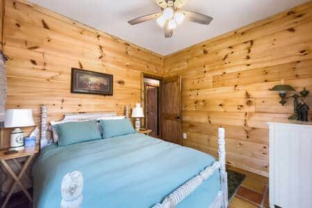 This is the second bedroom with french doors leading on to the back deck. 4 fans located in house. This is the second bedroom with french doors leading on to the back deck. 4 fans located in house.