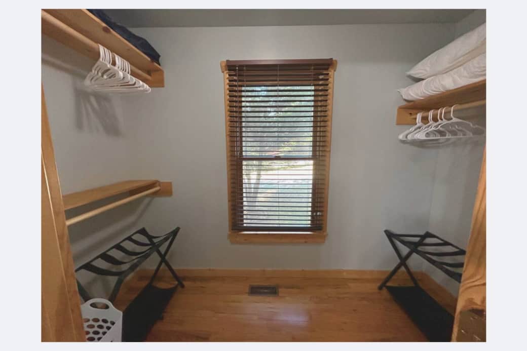 Walk in closet with 2 luggage racks and hamper