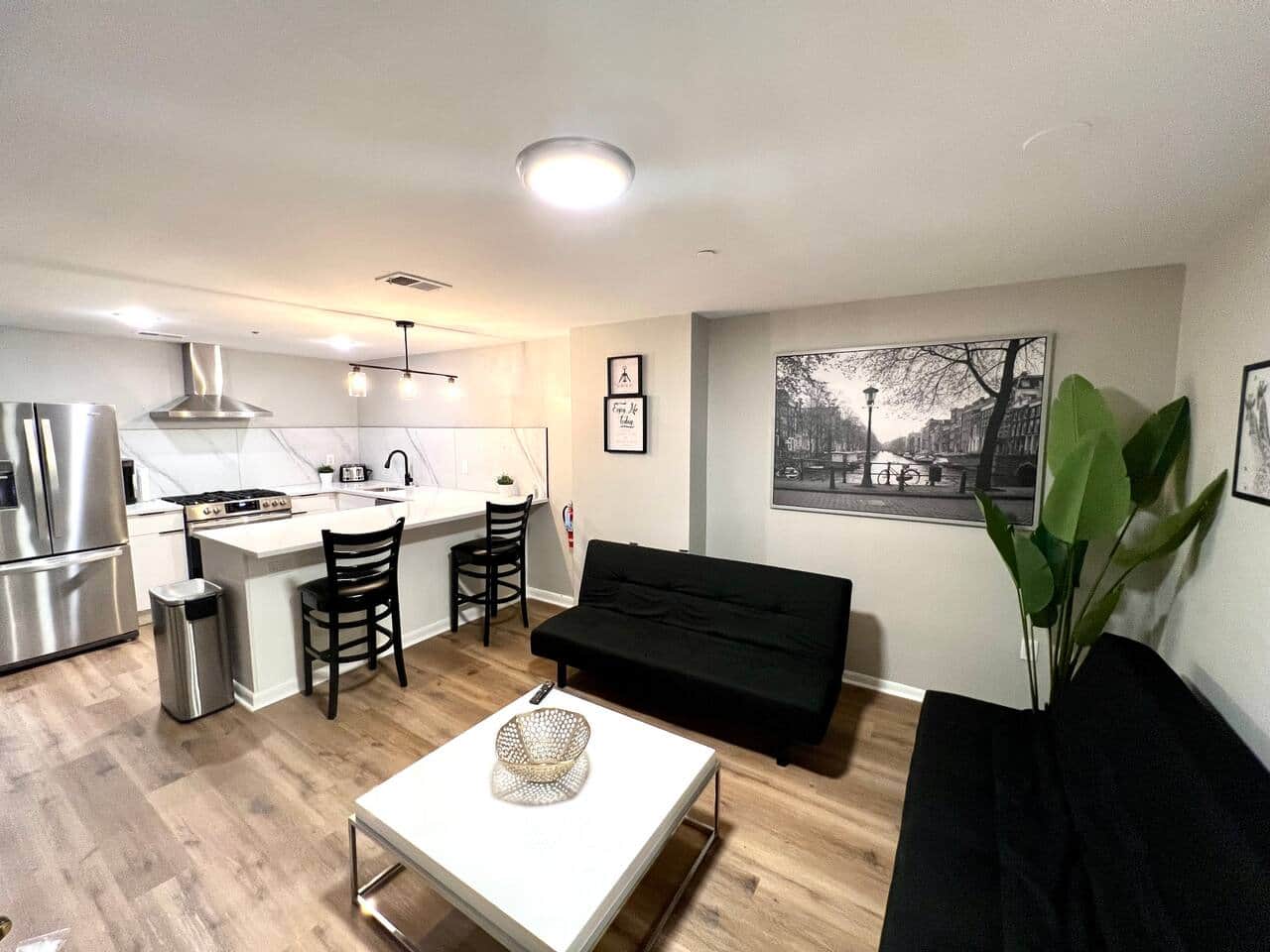 The living room features two comfortable futon sofa beds, perfect for relaxing or accommodating extra guests. 55 inch flat-screen TV, equipped with a variety of Roku channels, and an electric fireplace..