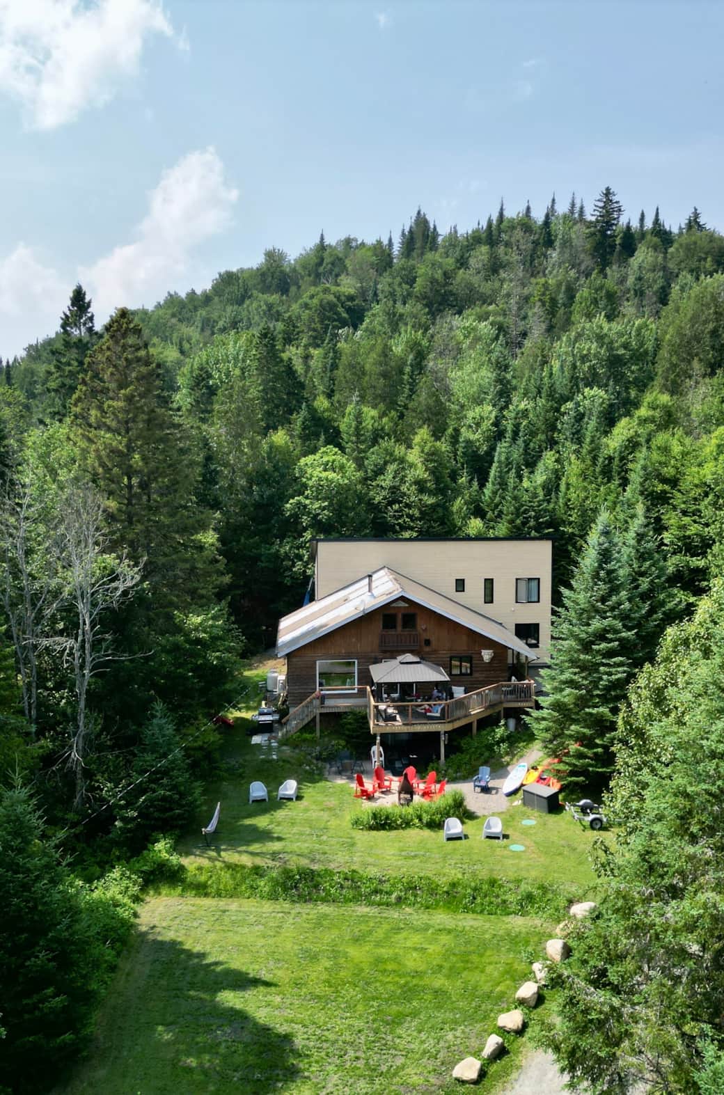 Aerial view cottage surrounded with forest and private