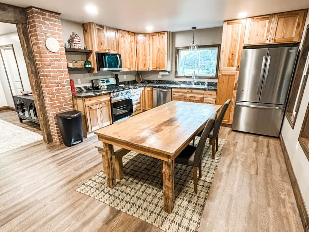 Gather ‘round the rustic dining table for home-cooked meals, game nights, or morning coffee in this warm and welcoming kitchen. Gather ‘round the rustic dining table for home-cooked meals, game nights, or morning coffee in this warm and welcoming kitchen.