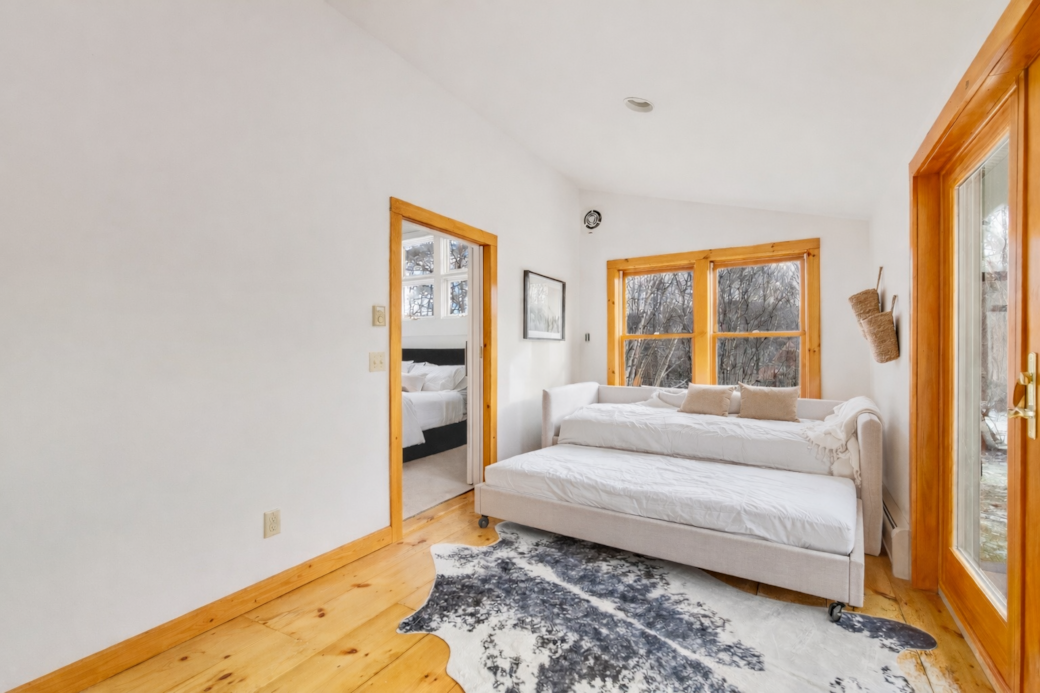 Cozy guest bedroom accessible through the primary bedroom with flexible sleeping options