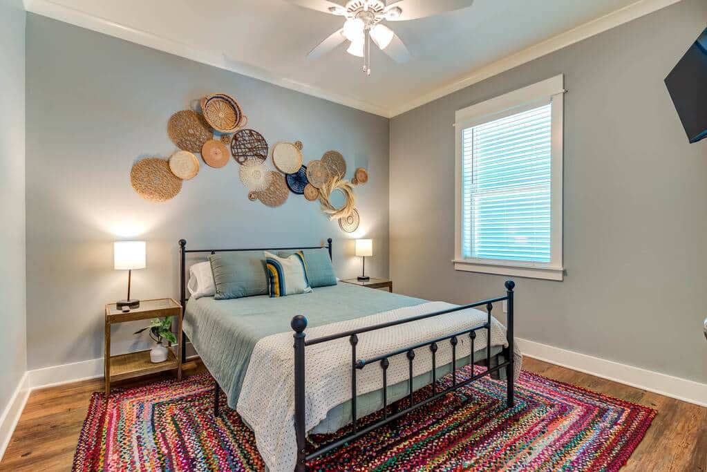 Queen guest bedroom with television and large walk-in closet