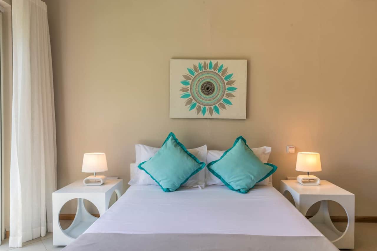 Comfortable and spacious bedroom with A/C and fan, ensuite bathroom