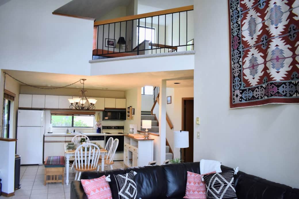 View from the living room to the kitchen and open loft above.