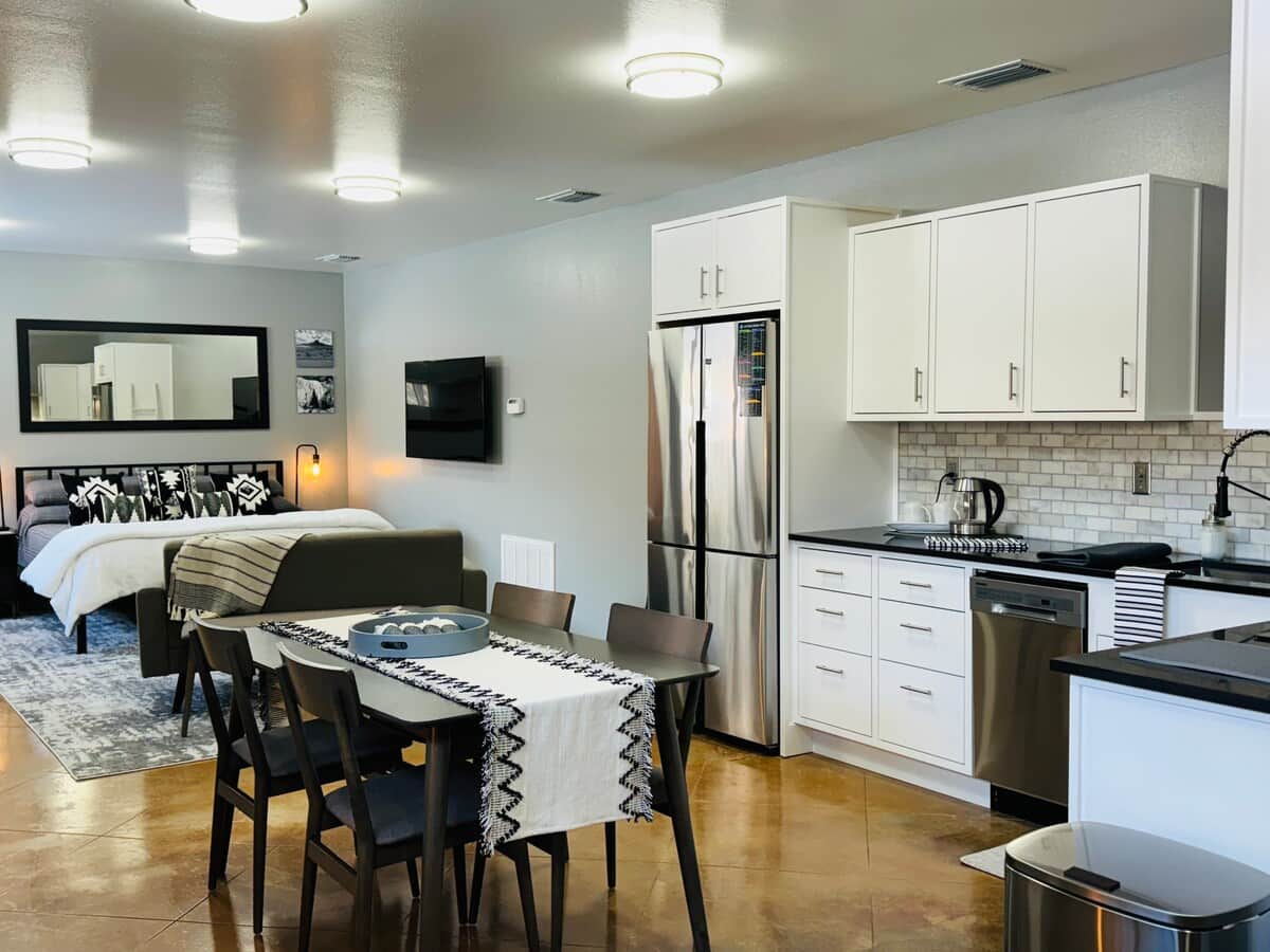 Studio with king bed, dining table and kitchen