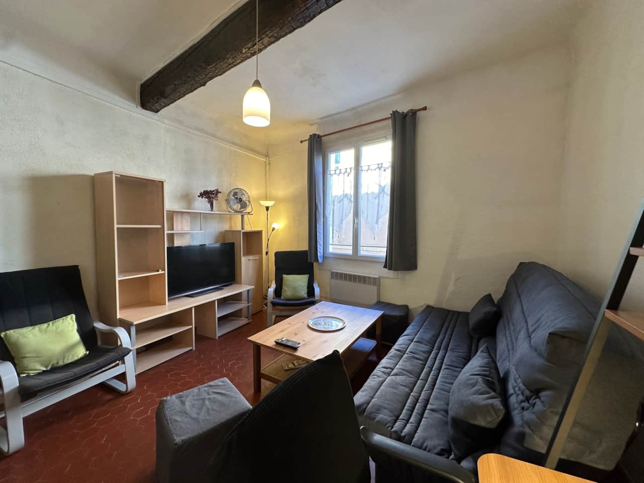 living room, convertible sofa, TV, storage space, fan, chairs
