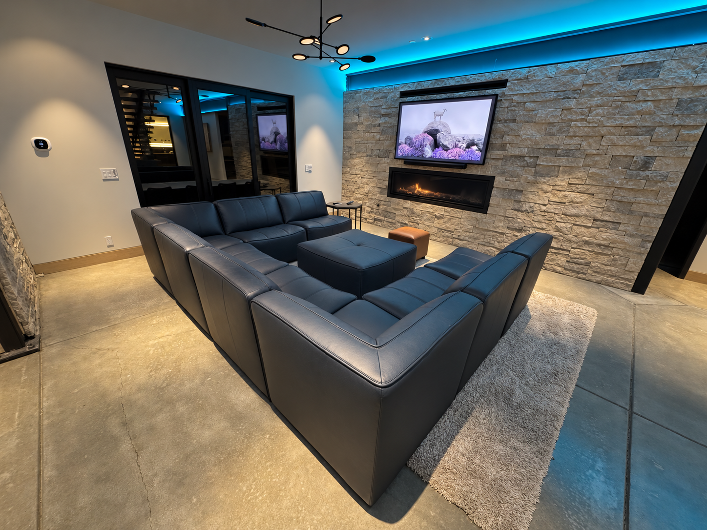 Basement theater seating, fireplace and colorful accent lighting.