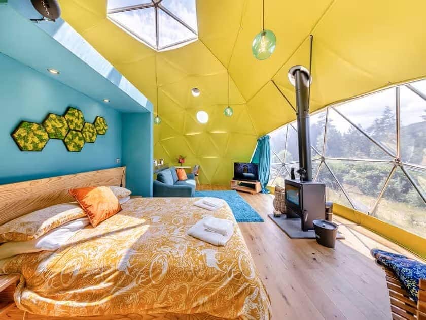 King-size bed, wood burner and countryside views inside the spacious dome