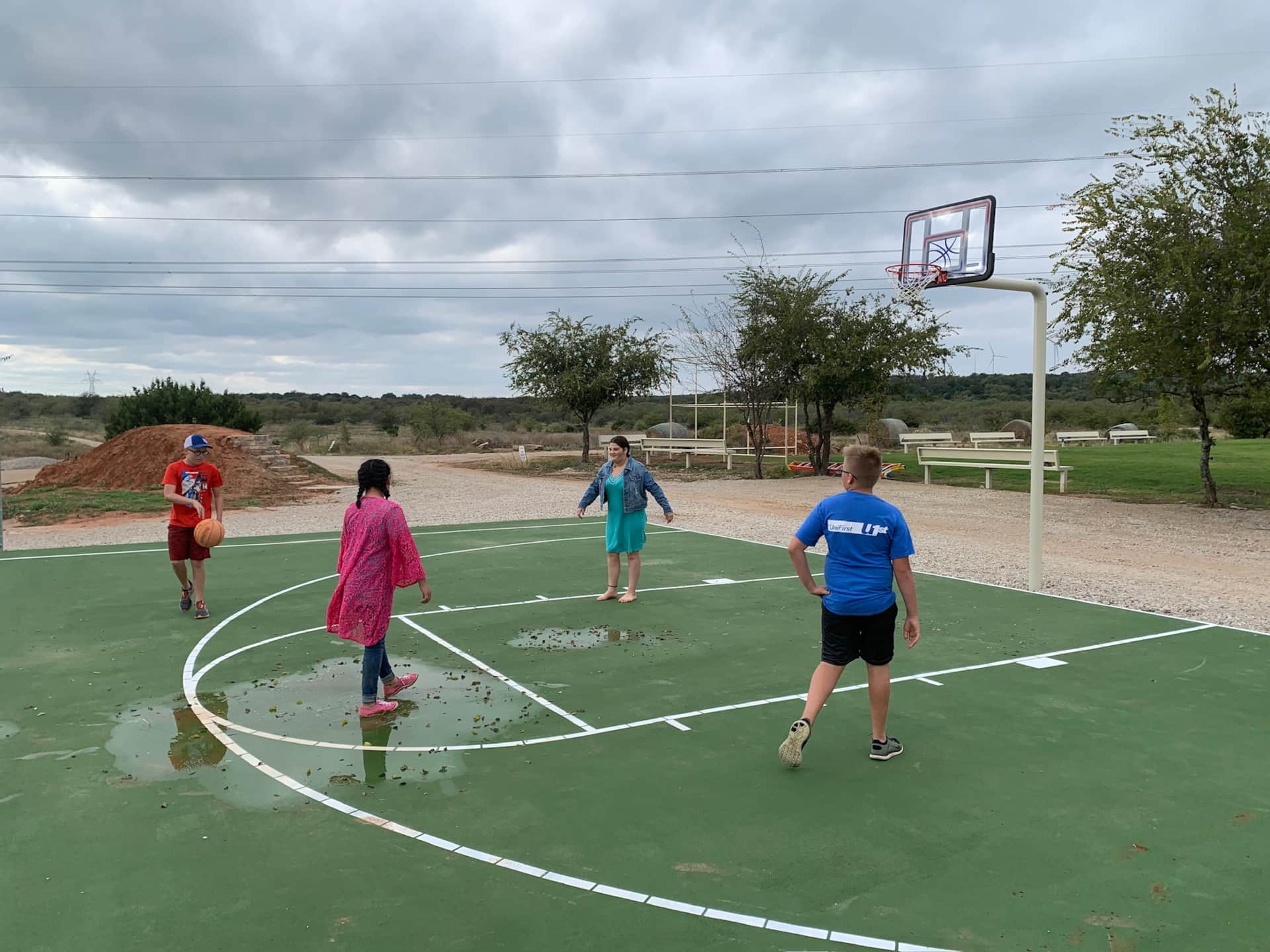 Youth group enjoying lit basketball court at Lake Godstone during a church or family retreat