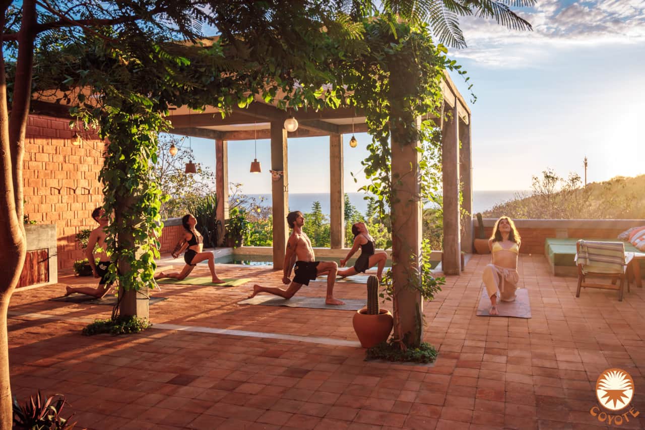 Sunset yoga beside the pool with Pacific Ocean views