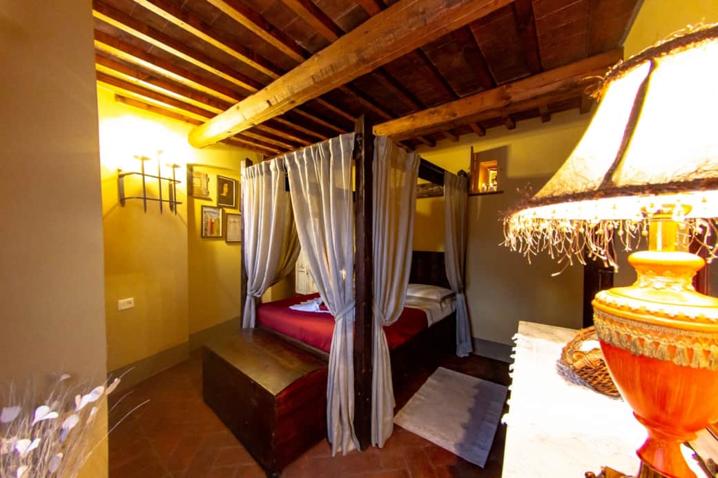 1 of the 2 double bedrooms with four poster bed