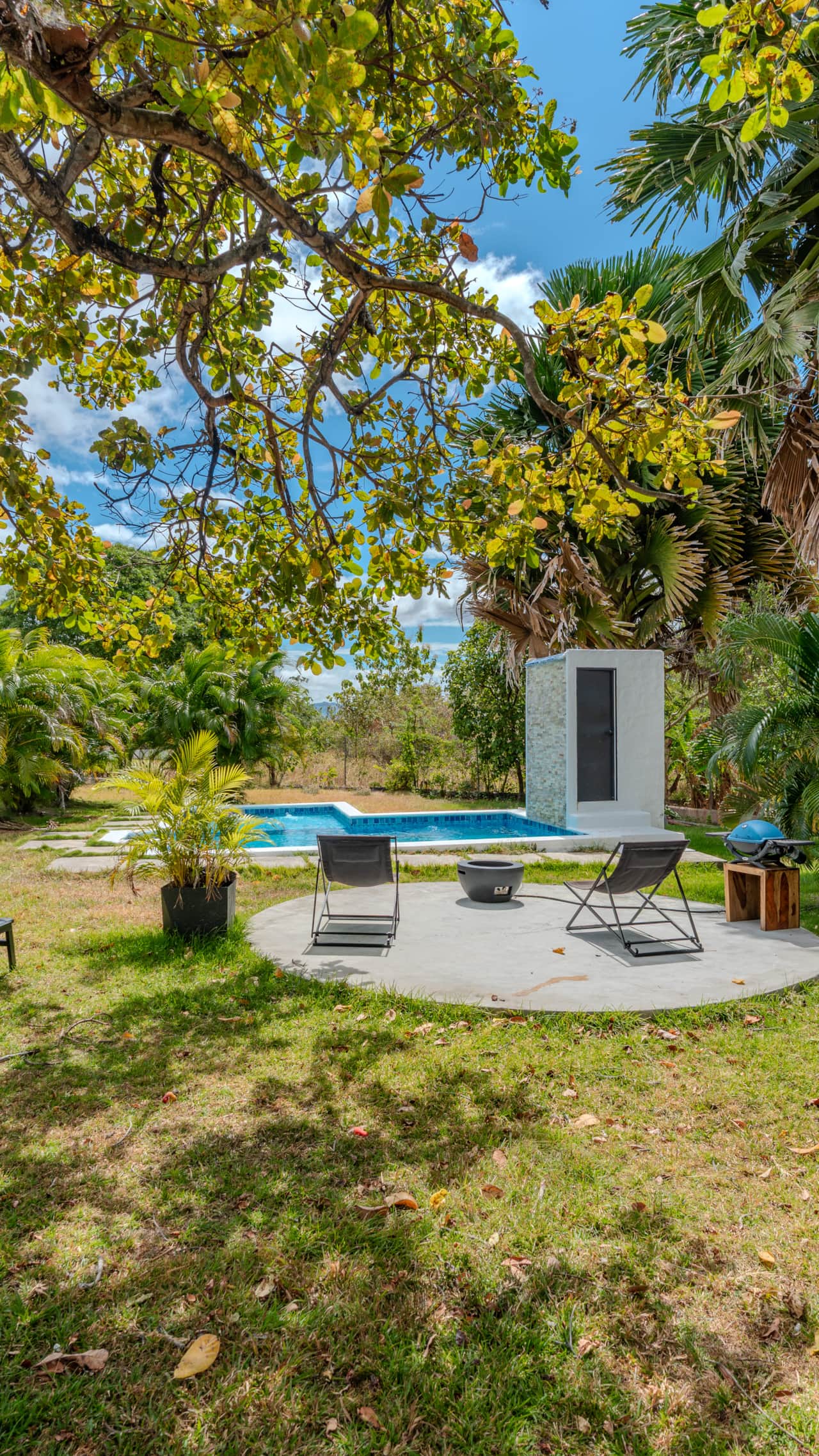 Garden lounge with fire pit and pool at an off-grid eco retreat near Playa Coronado, Panama