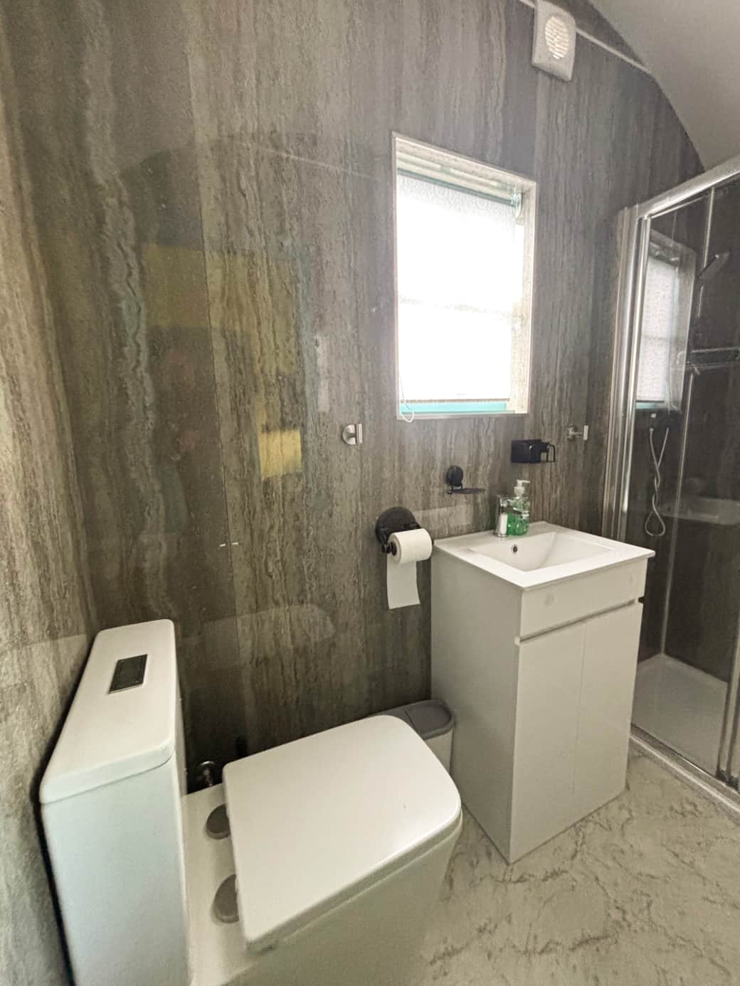 Modern ensuite with sleek finishes and walk-in shower.
