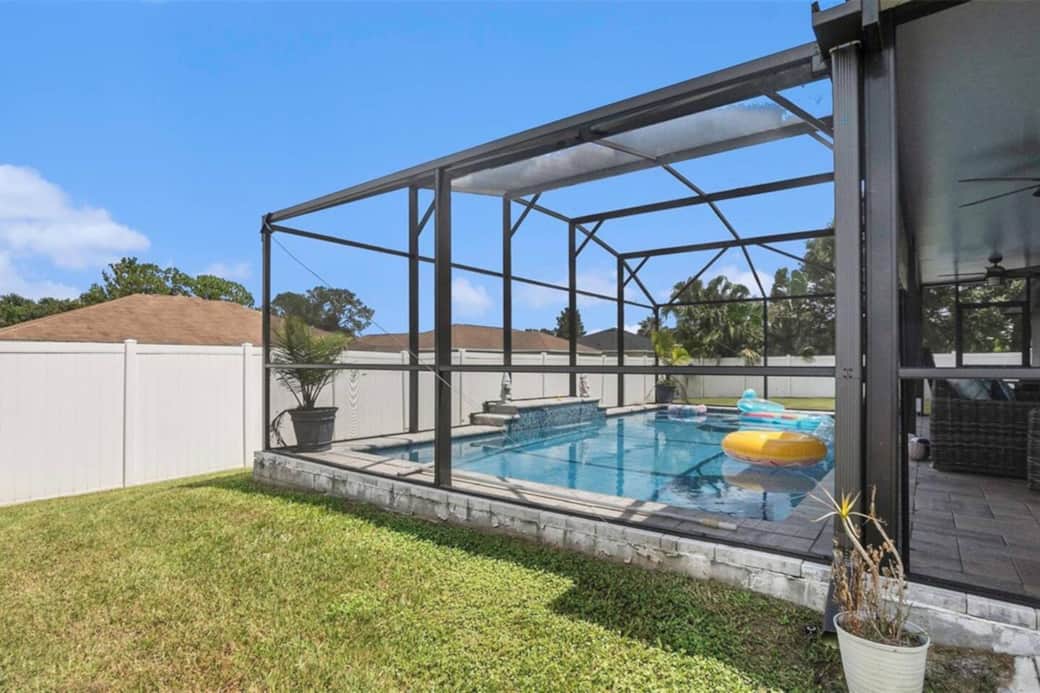 Grass area for kids to play in a spacious, fully fenced yard