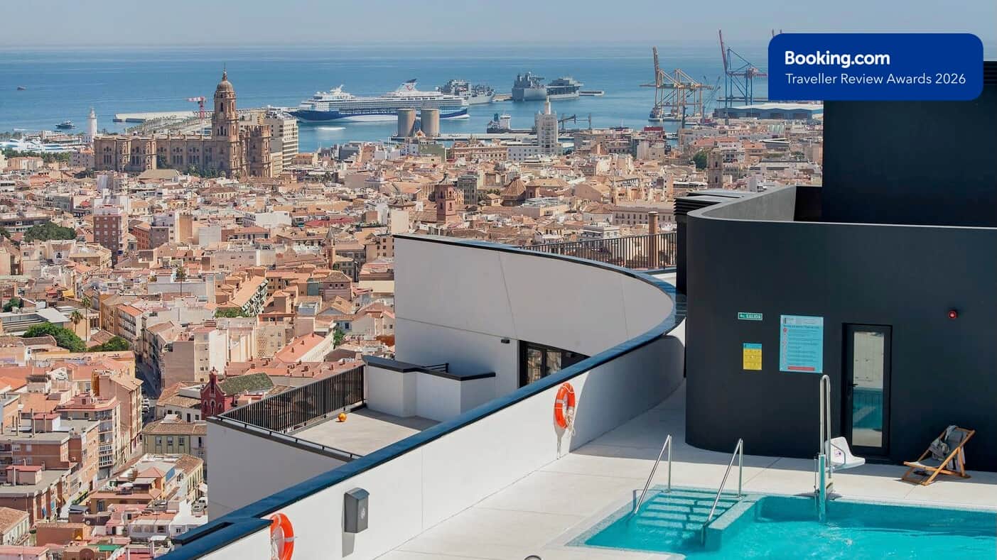Rooftop pool with panoramic views of Malaga Cathedral and the Mediterranean port.