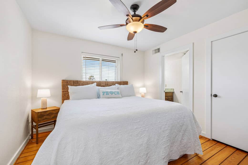 Master bedroom on main level features king bed and en suite bathroom. Master bedroom on main level features king bed and en suite bathroom.