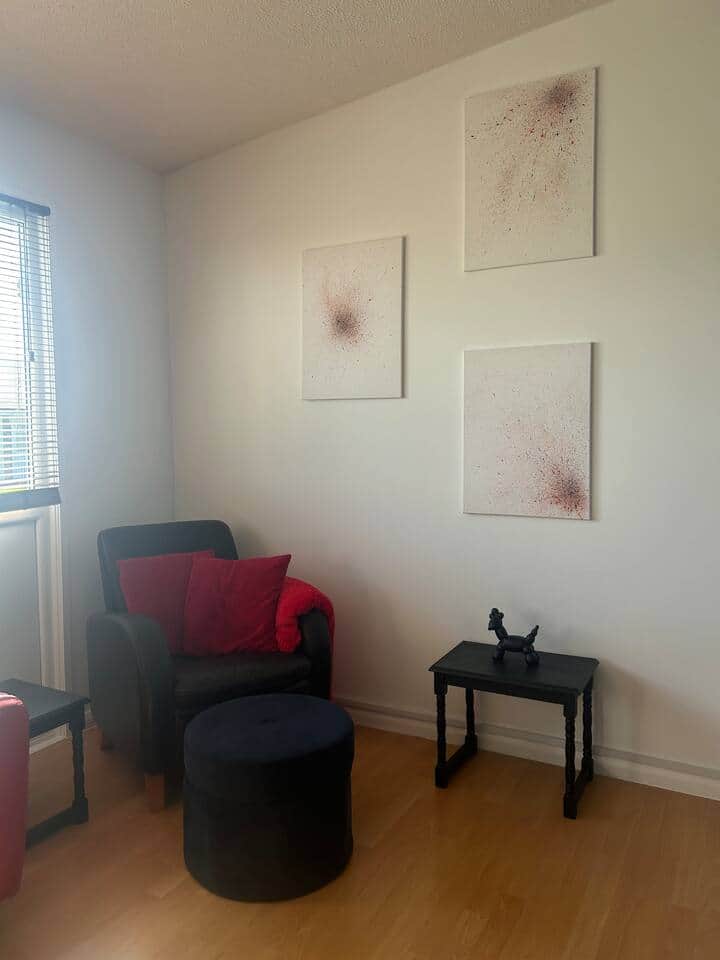The cosy corner of the living room, featuring original local artwork 
