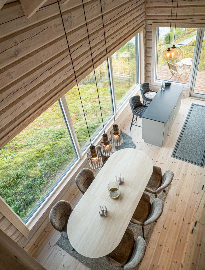 Dining table below the panoramic window, seen from the gallery