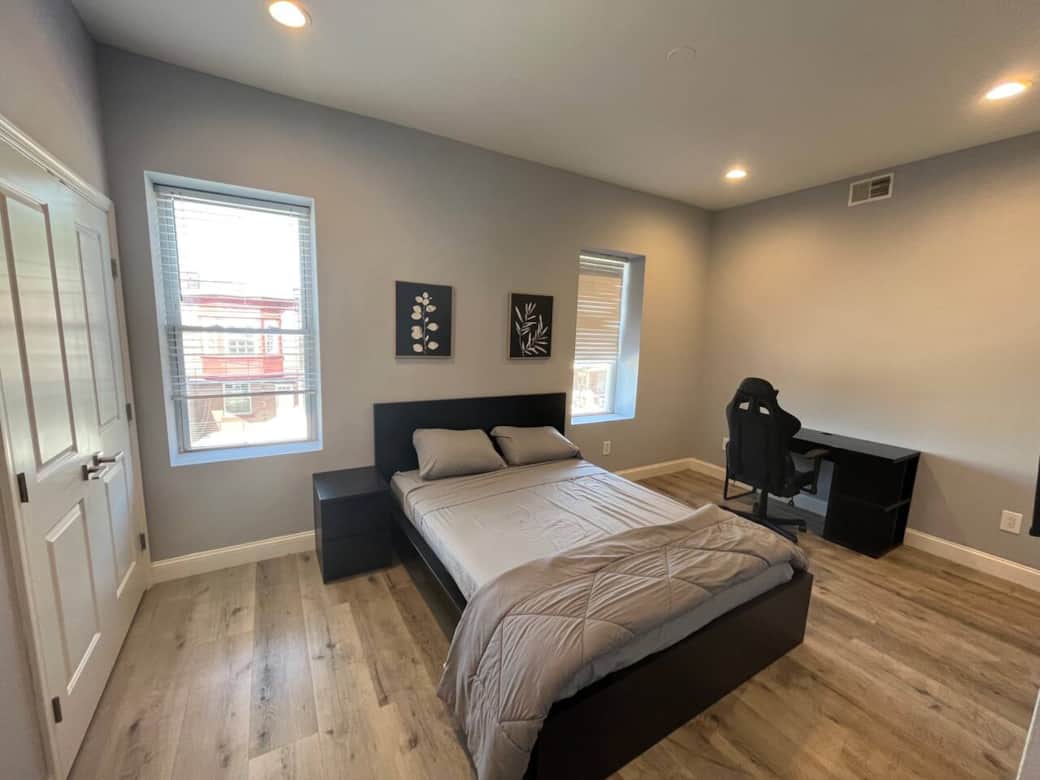 This comfortable bedroom includes a queen bed, flat-screen TV, darkening curtains, a side table, USB charging, lamp, and a spacious closet for all your storage needs.
