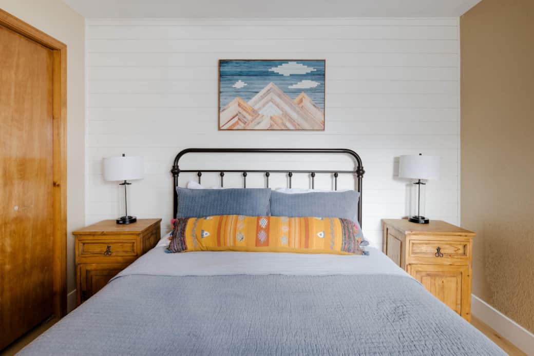 The second bedroom hosts a queen bed, new floors and lots of light.