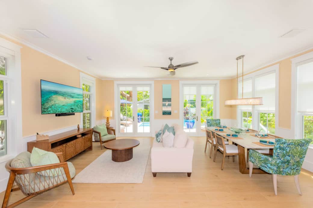 Bright family room with open-concept design, pool access, and relaxed coastal style. Bright family room with open-concept design, pool access, and relaxed coastal style.