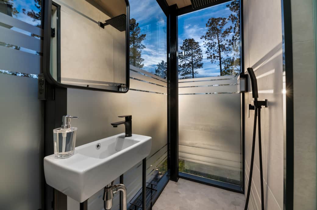 Bathroom with a view - rain head shower, hand held shower head, sink, mirror, & toilet