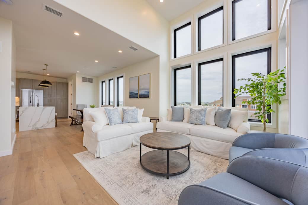 Spacious living room with floor-to-ceiling ocean views at Driftwood Carolina