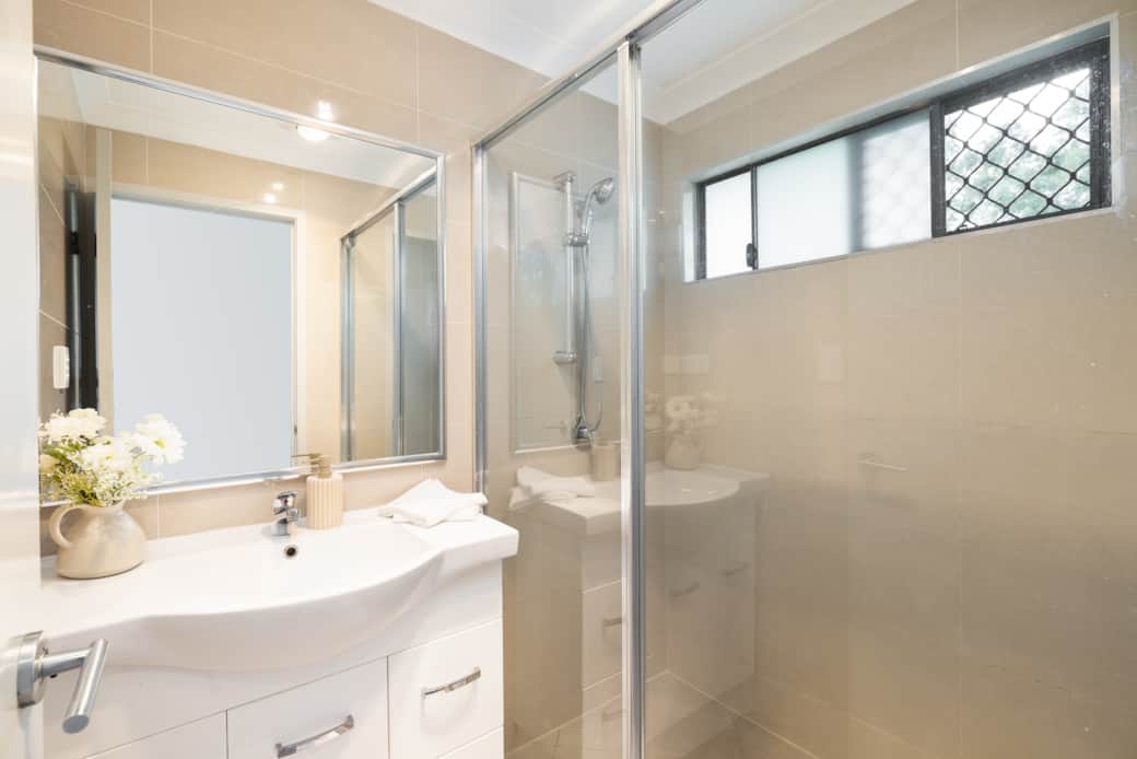 Bathroom: Stylish bathroom with walk-in shower, vanity, and clean finishes