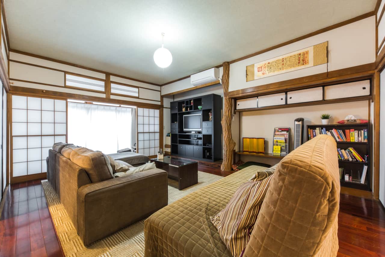 Spacious living area with comfy sofas and entertainment centre