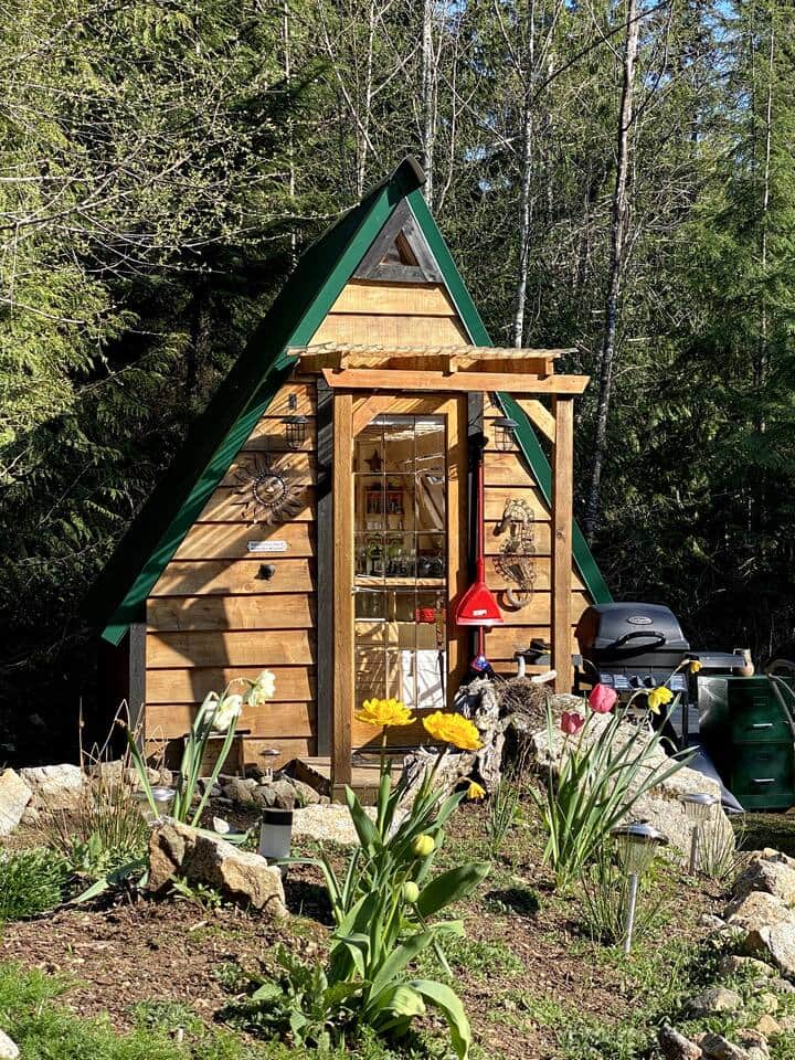 Lovely landscaping surrounds the A-frame Lovely landscaping surrounds the A-frame