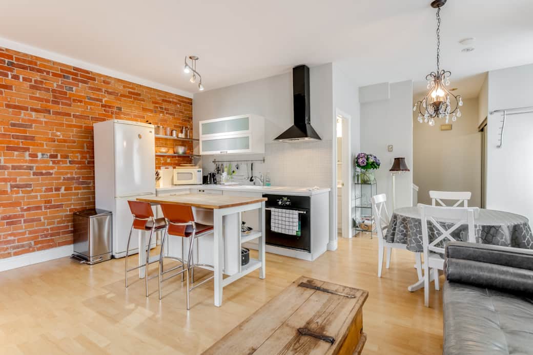 Sunlit and airy lounge space in a Toronto short-term lodging, both roomy and welcoming
