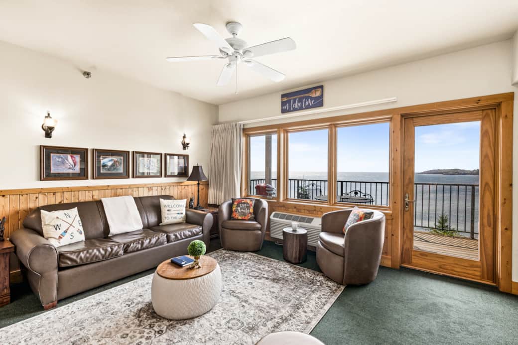 Cozy chairs, crackling fire, and the lake stretching out beyond the glass—pure serenity