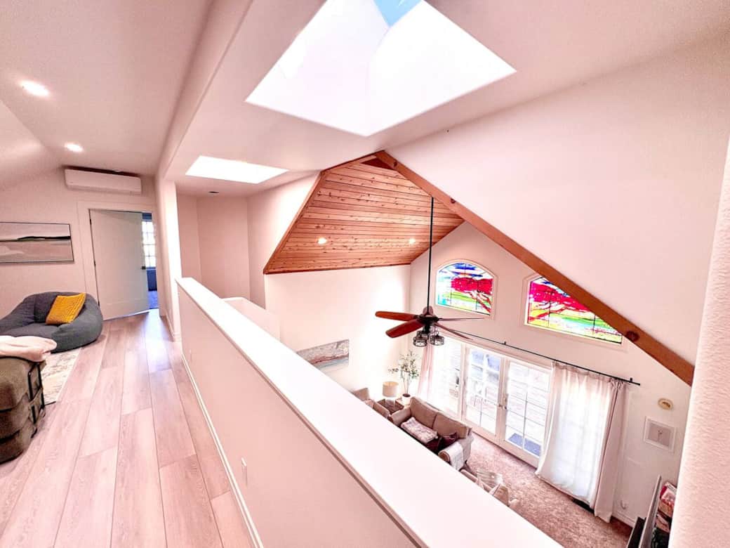 Filled with natural light, the *New* loft overlooks the main living area and provides a flexible space where guests can gather, play games, read, or unwind.