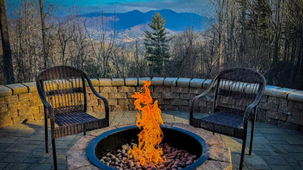 Easy-ignite gas fire pit framing mountain silhouettes