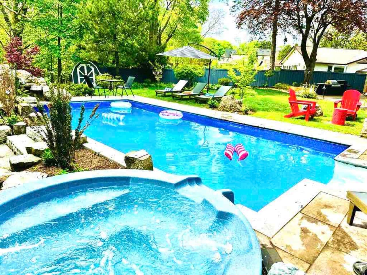 Our backyard offers a true resort like feel with a pool and connected spa jacuzzi, water fall, lounge chairs and a view of the beautiful ravine. 