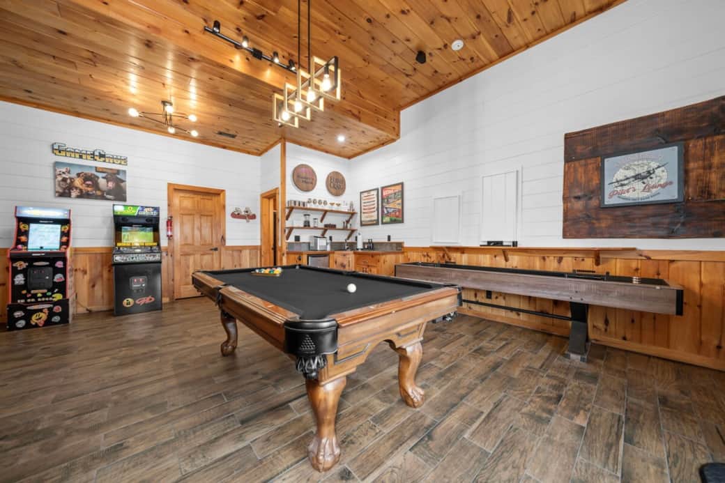 Newly felted and pocketed pool table, shuffleboard, and darts for the ultimate game night. A personal mini bar with a mini fridge, sink, and icemaker makes this space a crowd-pleaser.