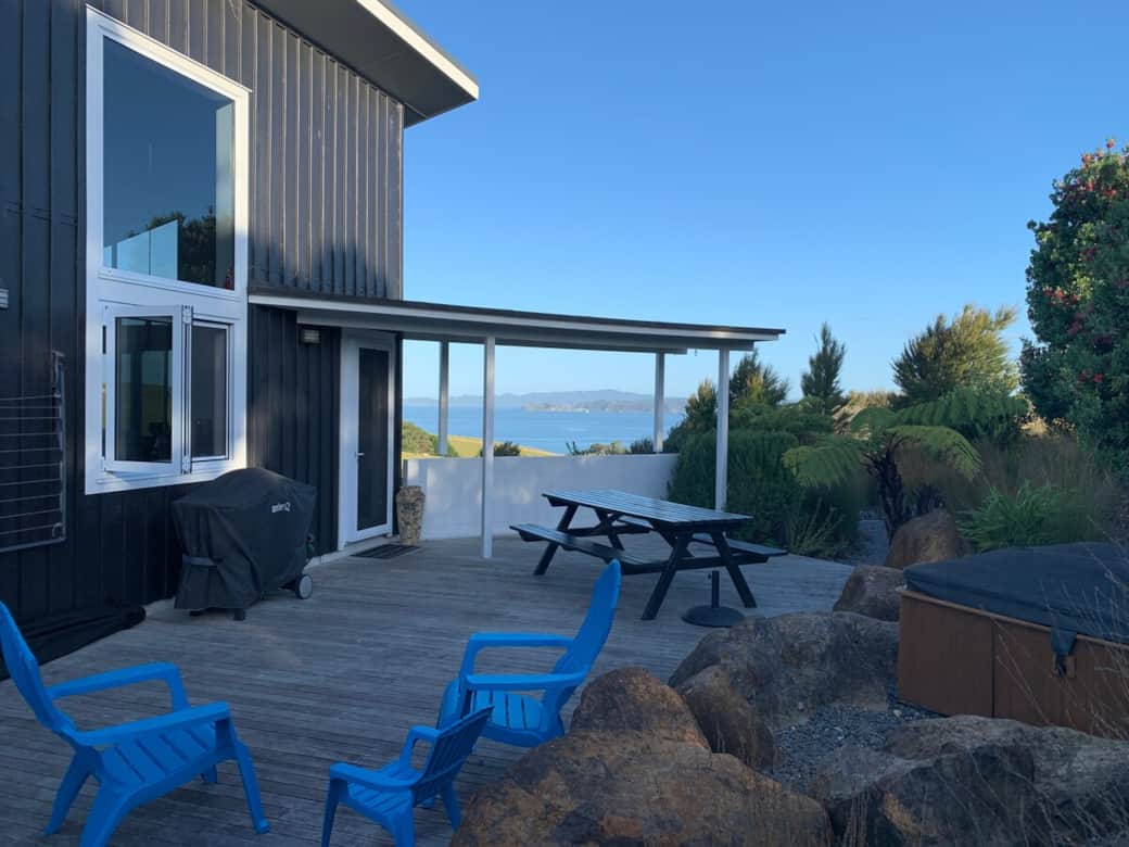 Secluded back patio with BBQ, outdoor dining and spa pool at Wharau Lodge. Historic Bay Of Islands.