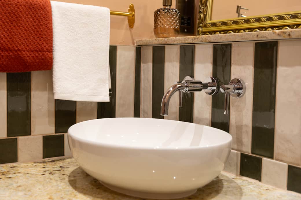 Elegant fixtures and a minimalist aesthetic create a calming, spa-like atmosphere.