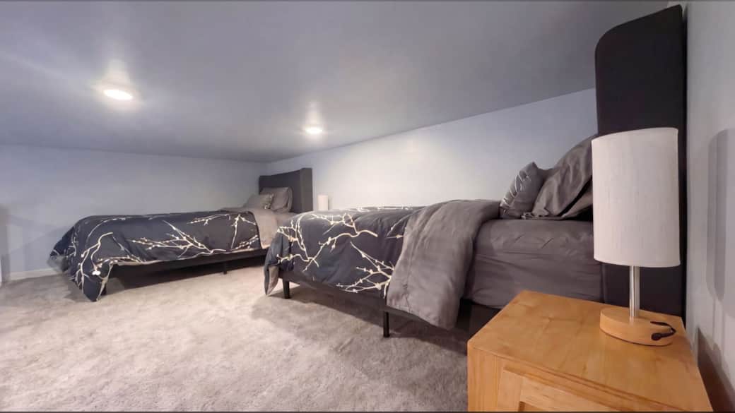 Sleeping loft with two twin beds and premium linens in the Black Hills, SD.