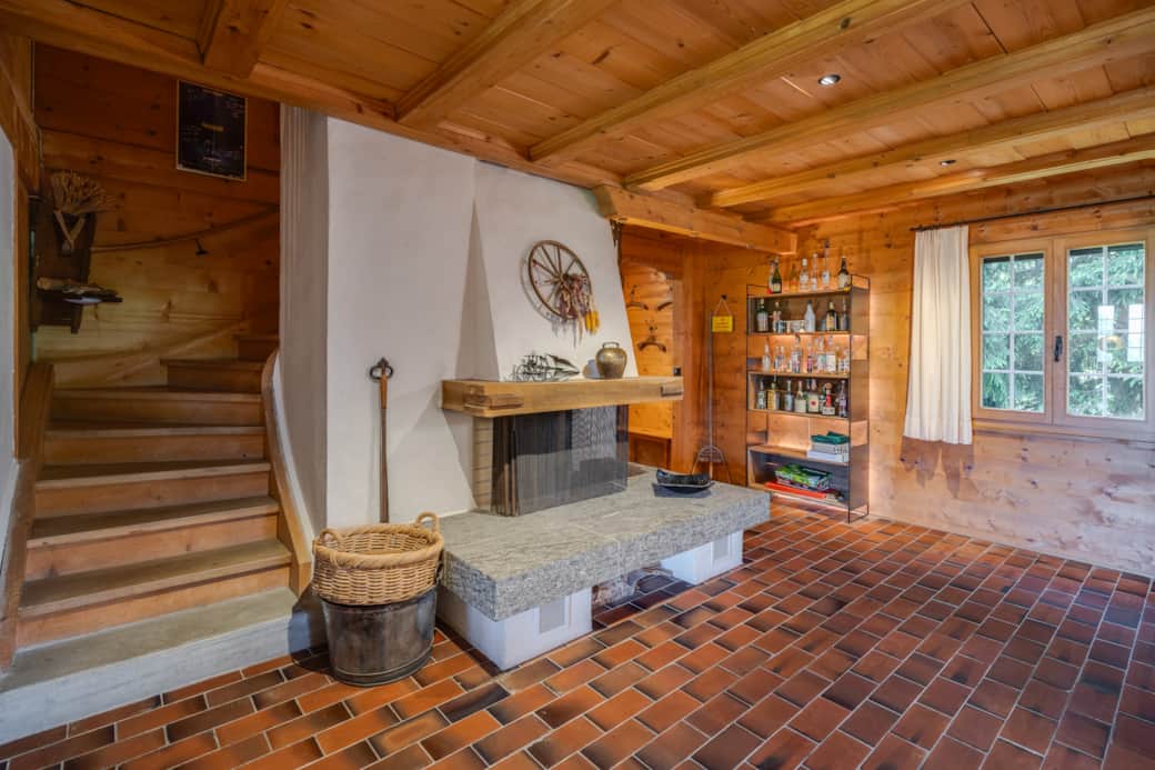 Large dining room with a cozy fireplace and massive oak table, seating 10 people.