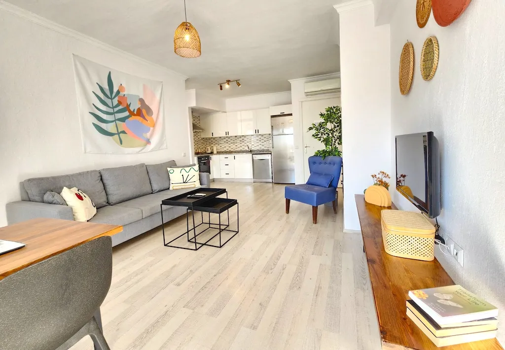 Living room with a gray sofa, blue armchair, coffee table, and TV, Apart Guney 7, Gocek