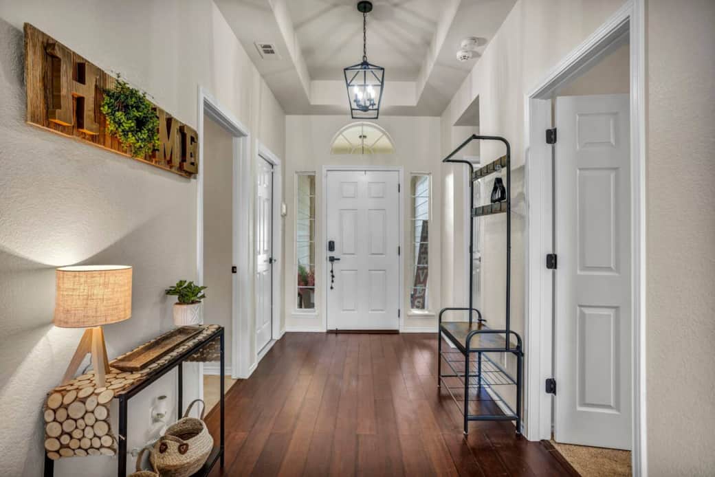 Bright and spacious entryway equipped with a hall tree to hang any excess clothing and shoes to keep your items organized and conveniently accessible. Bright and spacious entryway equipped with a hall tree to hang any excess clothing and shoes to keep your items organized and conveniently accessible.