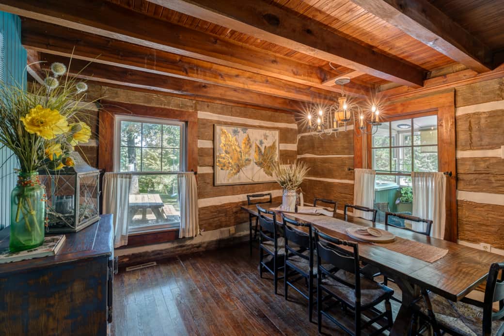 Historic log dining room offers a generous table for shared meals